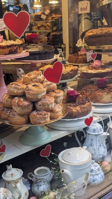 Pastries and teapots in a café window