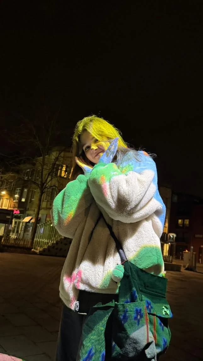 Carolina Luca, portrait at night in a colourful fleece